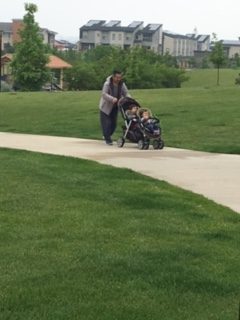 Grandfather pushing stroller